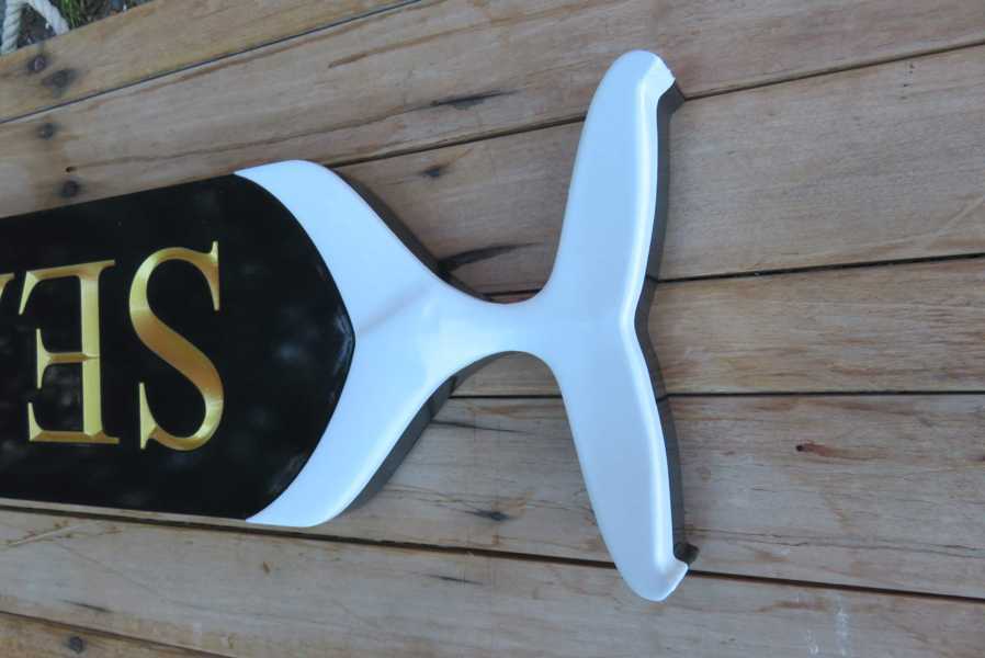 Carved whale tail end on end of quarterboard
