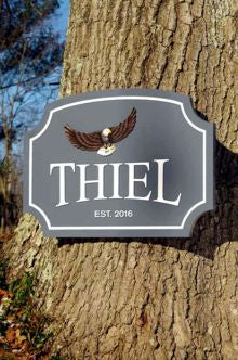 Thiel family name sign with flying eagle front view
