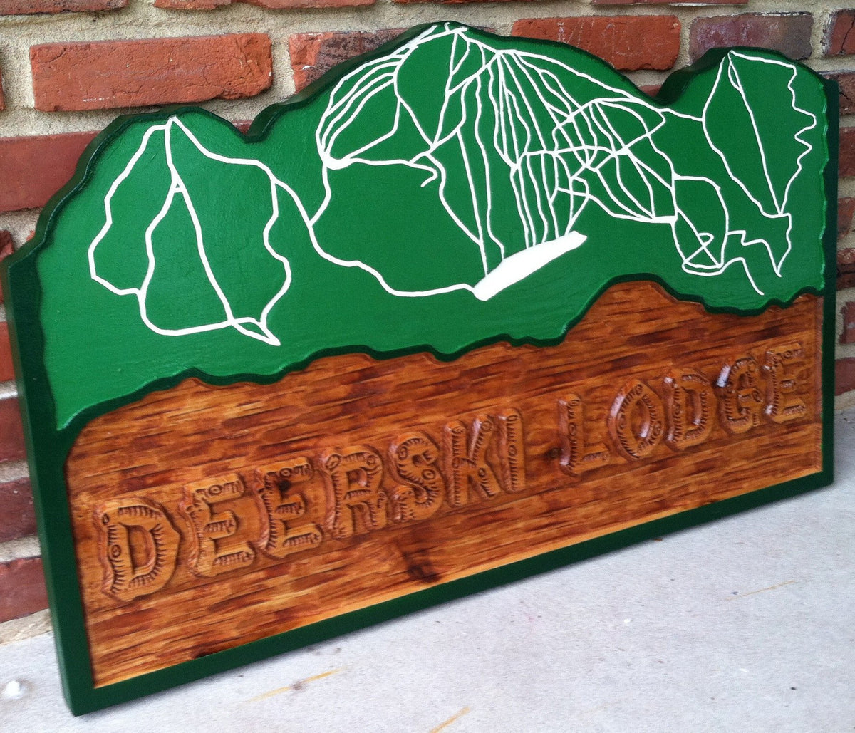 Lodge sign with ski resort map carved in