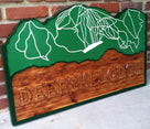 Lodge sign with ski resort map carved in
