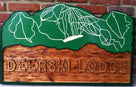 Lodge sign with rustic rugged font and ski trail map