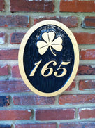 3 digit house number with fancy font and shamrock easy to read black and gold color scheme