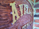 Western theme bar sign with est date close up