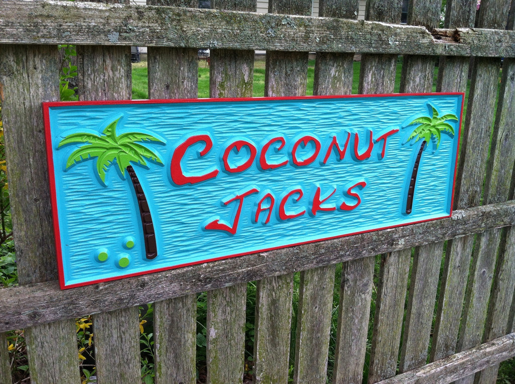 Tiki bar sign with coconut trees