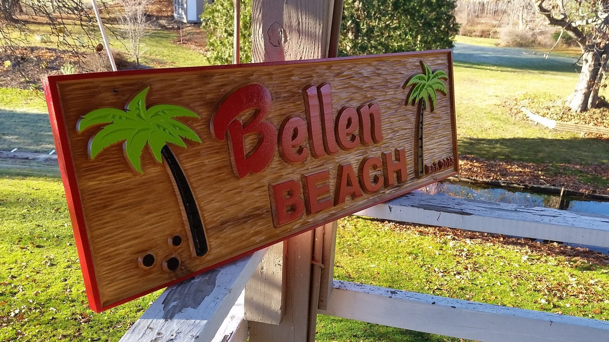 Bellen beach sign with coconut trees