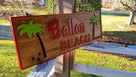 Bellen beach sign with coconut trees