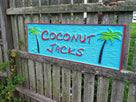 Coconut Jacks sign with coconut trees and pirate font