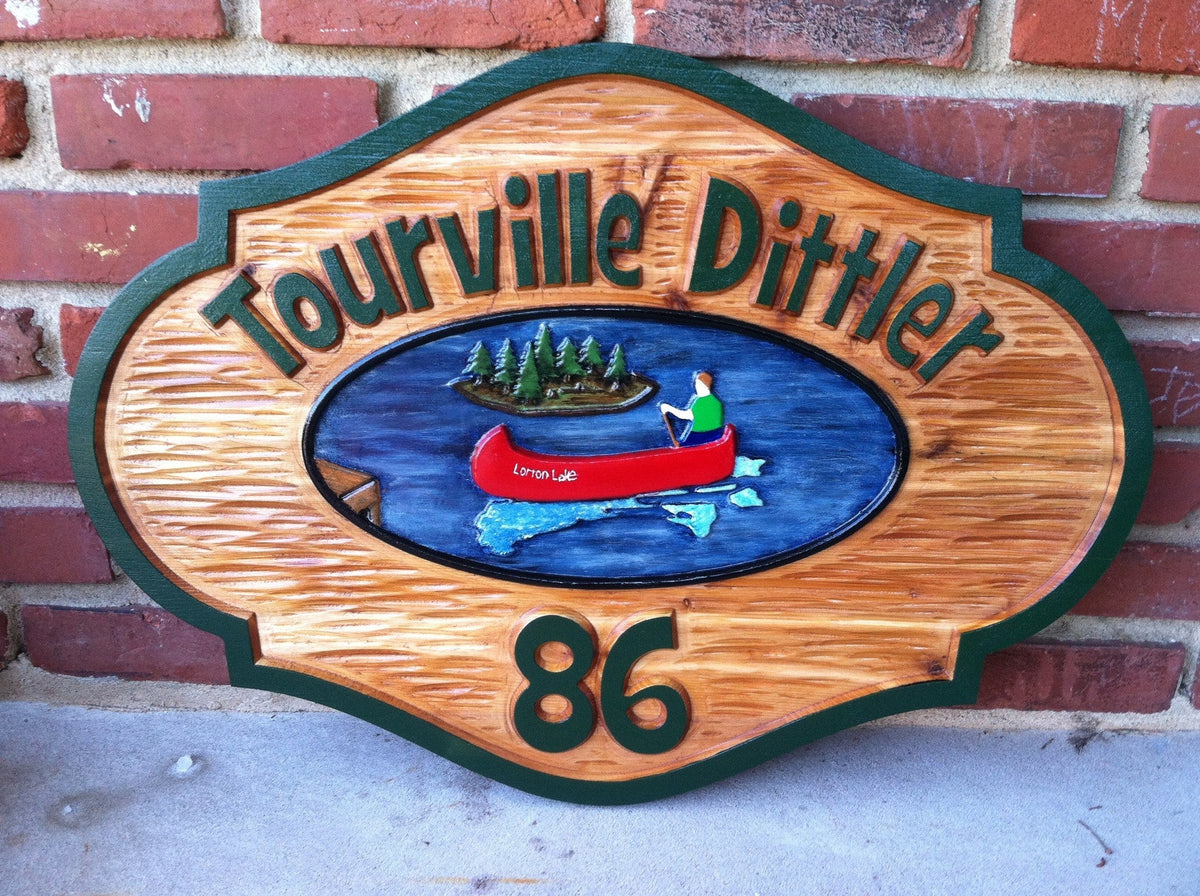 2 name camp sign with number and hand painted canoe on lake image
