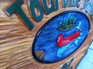 Cedar carved textured camp sign with canoe close up