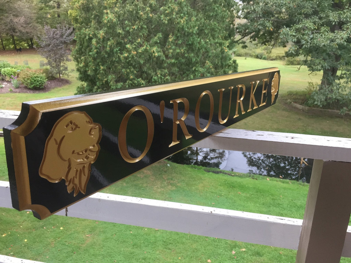 Side view of custom quarterboard with dog breed carved on it