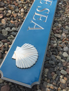 close up of scallop shell carved on quarterboard