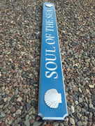 Side view of quarterboard with soul of the sea carved on it