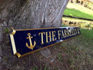 Quarterboard custom made with The Farrells carved on it painted blue and gold