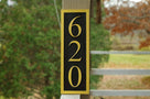 House number sign with 620 carved on it vertical position