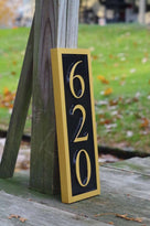 side view of 620 house number sign in vertical position painted black and gold