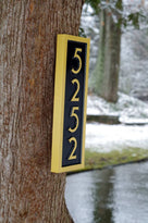 Side view of House number sign 5252 in black and gold mid century modern font