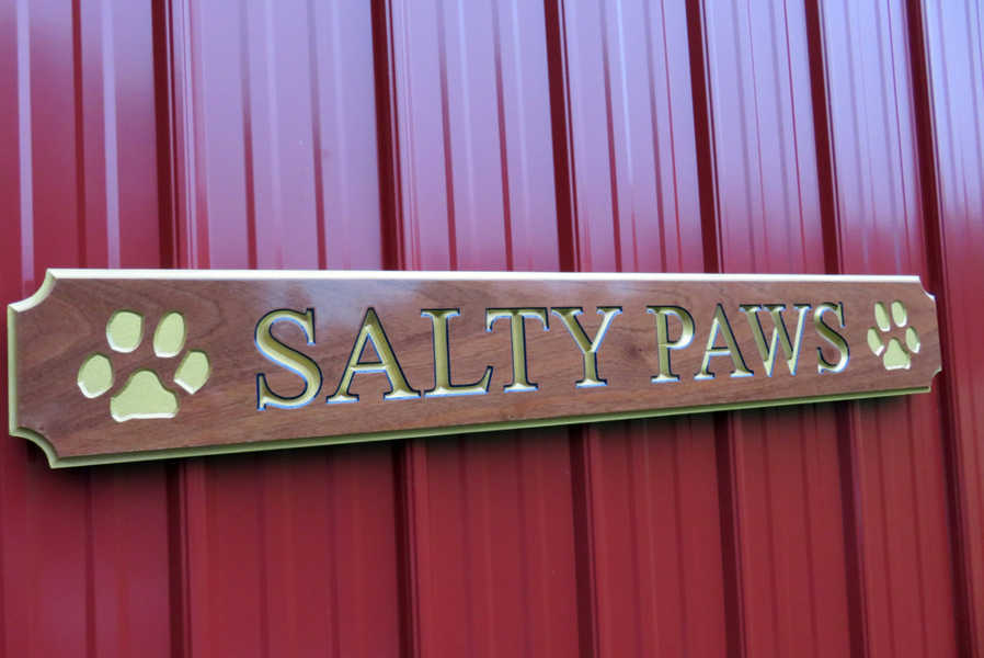 quarterboard carved from mahogany wood with Salty Paws carved on it