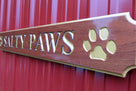 Angle view of quarterboard carved from mahogany wood with Salty Paws carved on it
