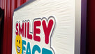 Side view of Orthodontist logo carved on rectangular sign painted in multiple colors