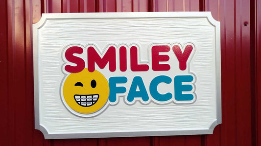 Orthodontist logo carved on rectangular sign