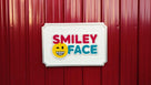Orthodontist logo carved on rectangular sign painted in multiple colors