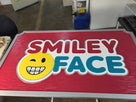 Dental logo carved on rectangular sign painted in pink