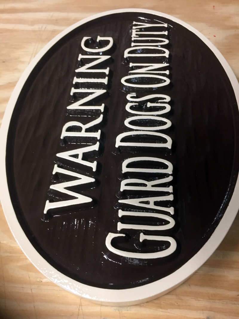 brown and cream dog warning sign