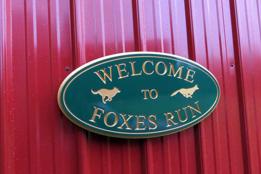 neighborhood entrance sign painted green and gold